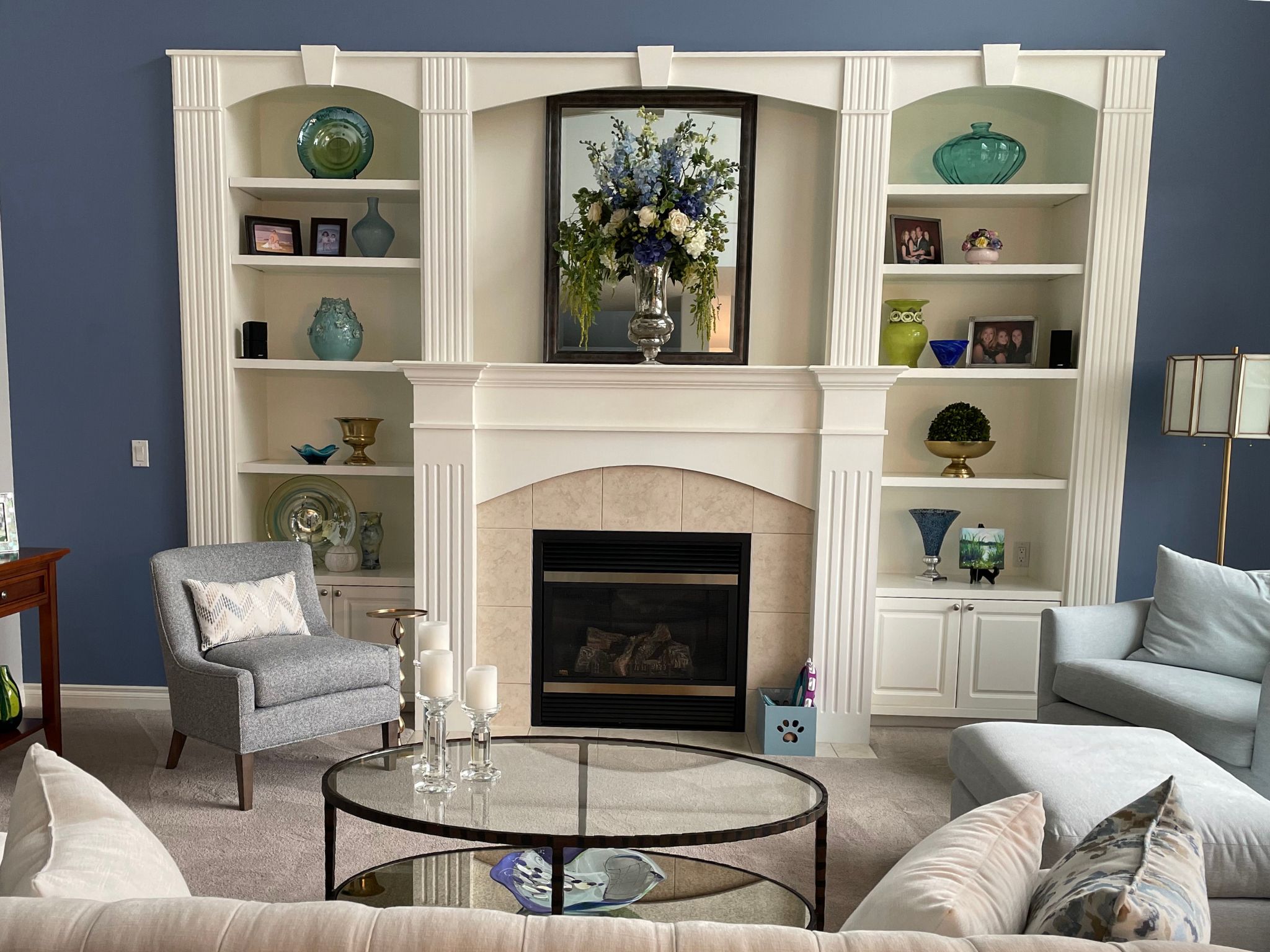 Large cream fireplace and built in shelving